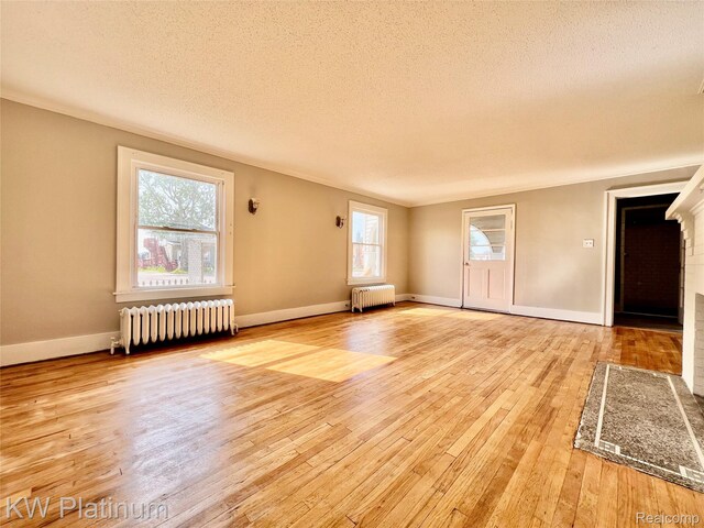 2109 Military St, Port Huron, MI 48060 - unfurnished room with radiator, hardwood / wood-style flooring, and a textured ceiling