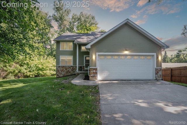 4577 Oaklawn Dr, Pinckney, MI 48169 - view of front facade with stone siding, driveway, and an attached garage