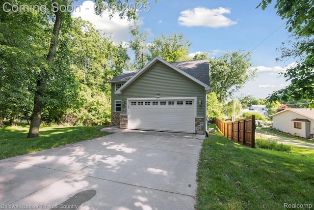 4577 Oaklawn Dr, Pinckney, MI 48169 - view of front of house with concrete driveway, a garage, and stone siding