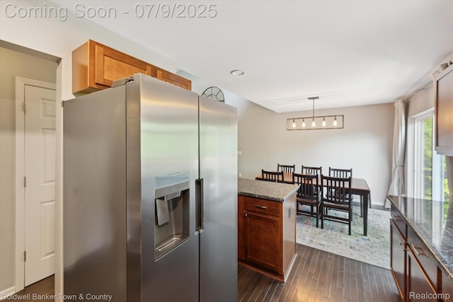 4577 Oaklawn Dr, Pinckney, MI 48169 - kitchen featuring stainless steel fridge with ice dispenser, dark wood-style floors, dark stone countertops, and hanging light fixtures