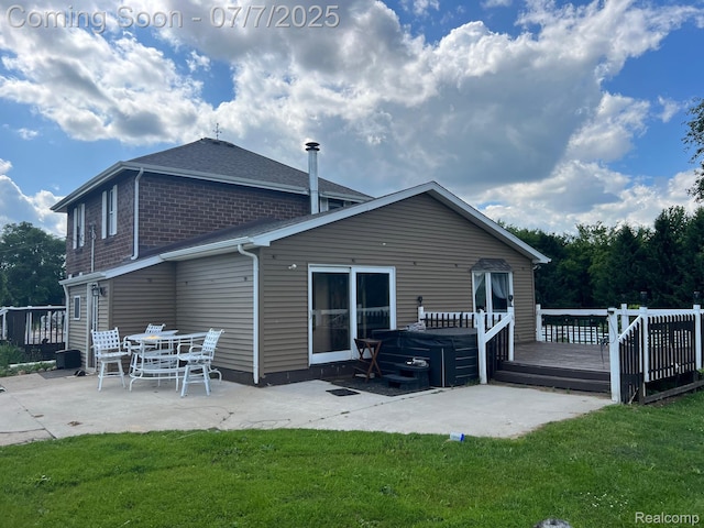 3500 Schlaud Rd, North Branch, MI 48461 - back of property featuring a patio area, a wooden deck, a lawn, and a hot tub