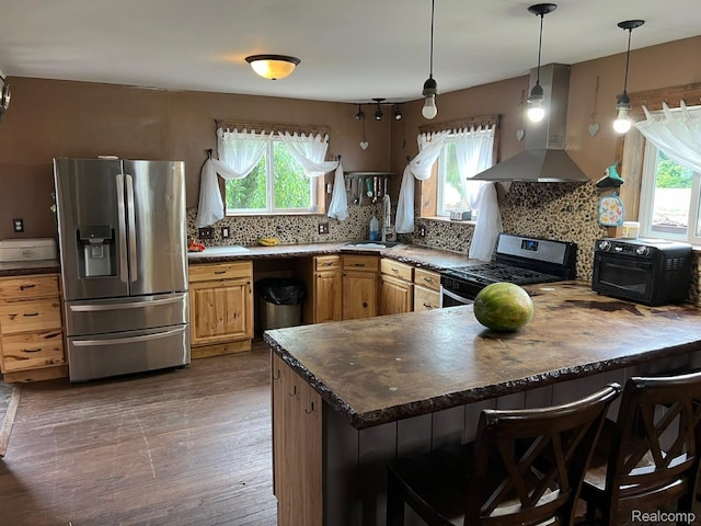 3500 Schlaud Rd, North Branch, MI 48461 - kitchen with stainless steel appliances, island range hood, healthy amount of natural light, and a peninsula