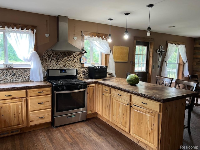 3500 Schlaud Rd, North Branch, MI 48461 - kitchen with stainless steel gas range oven, wall chimney range hood, a peninsula, dark countertops, and dark wood finished floors