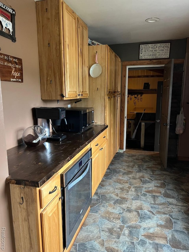3500 Schlaud Rd, North Branch, MI 48461 - kitchen with stone floors, dark countertops, and black microwave