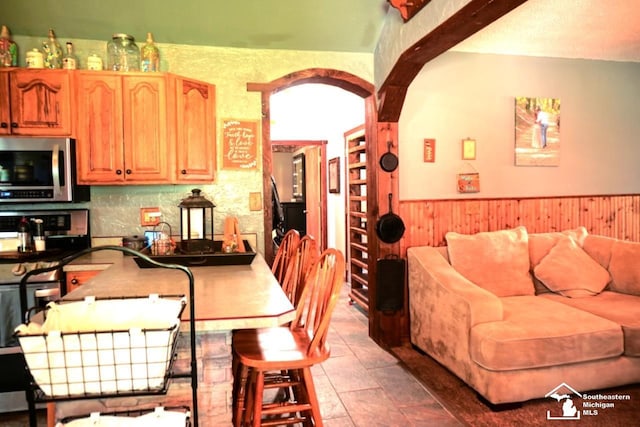 5985 Shady Ln, Newport, MI 48166 - kitchen featuring stainless steel appliances, wainscoting, and wood walls