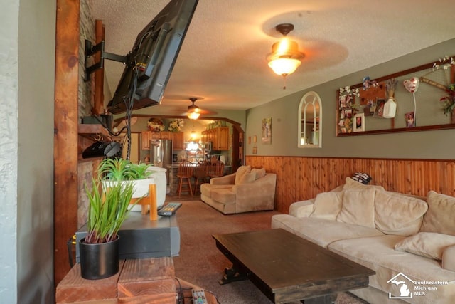 5985 Shady Ln, Newport, MI 48166 - carpeted living area with a ceiling fan, wainscoting, wood walls, and a textured ceiling