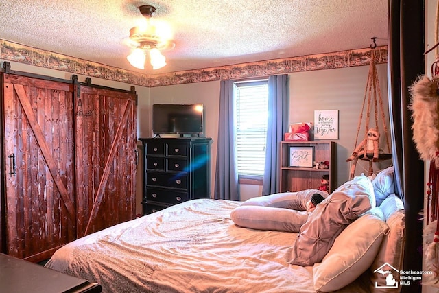 5985 Shady Ln, Newport, MI 48166 - bedroom with a textured ceiling and a barn door