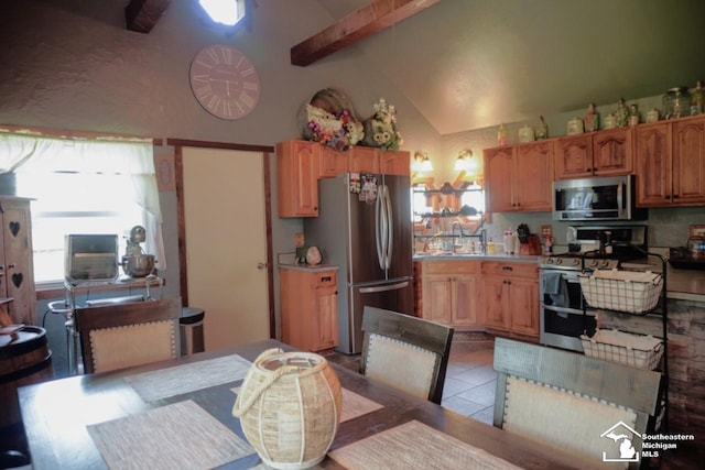 5985 Shady Ln, Newport, MI 48166 - kitchen featuring appliances with stainless steel finishes, beam ceiling, light countertops, light tile patterned floors, and high vaulted ceiling