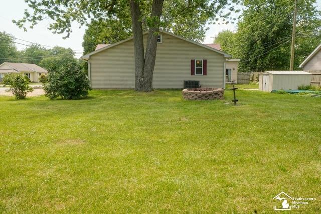 5985 Shady Ln, Newport, MI 48166 - view of yard featuring a storage unit and a fire pit