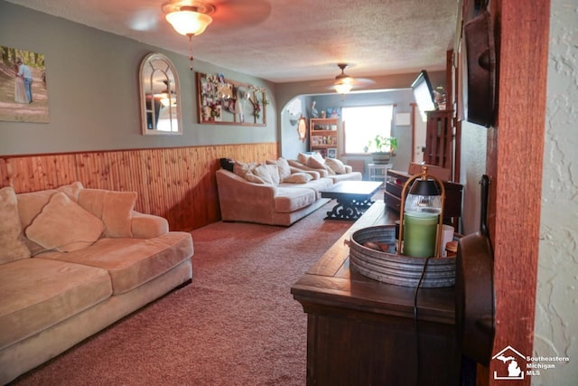 5985 Shady Ln, Newport, MI 48166 - carpeted living room featuring ceiling fan, wainscoting, wooden walls, and a textured ceiling