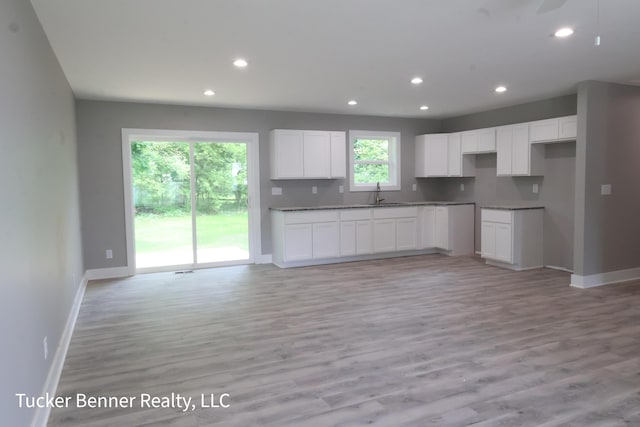 518 S Sullivan Ave, Fremont, MI 49412 - kitchen featuring light wood-style flooring, recessed lighting, white cabinets, and open floor plan