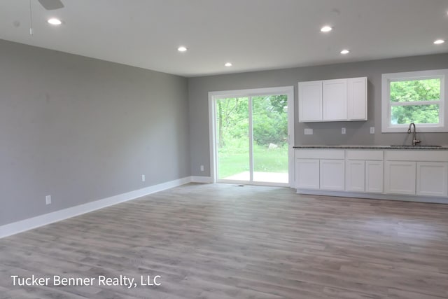 518 S Sullivan Ave, Fremont, MI 49412 - kitchen featuring recessed lighting, white cabinets, light wood-style floors, dark stone counters, and open floor plan