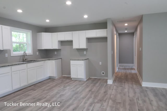 518 S Sullivan Ave, Fremont, MI 49412 - kitchen featuring light stone counters, white cabinets, light wood finished floors, and recessed lighting