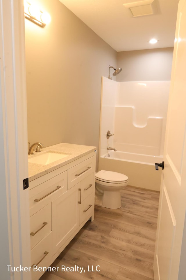 518 S Sullivan Ave, Fremont, MI 49412 - bathroom with vanity, wood finished floors, and shower / washtub combination