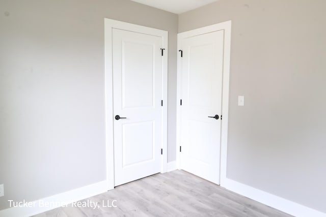 518 S Sullivan Ave, Fremont, MI 49412 - unfurnished bedroom featuring baseboards and light wood-type flooring