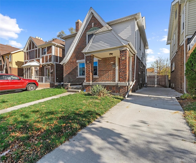 16554 Muirland St, Detroit, MI 48221 - view of front of property featuring brick siding, driveway, a porch, and a front yard