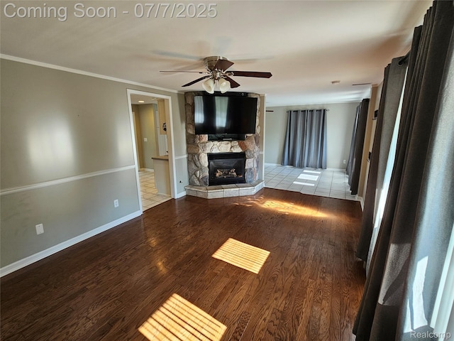 53120 Odilon Ave, Shelby Twp, MI 48316 - unfurnished living room with ceiling fan, wood finished floors, a stone fireplace, and crown molding
