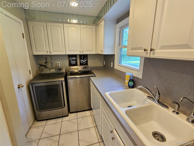 53120 Odilon Ave, Shelby Twp, MI 48316 - kitchen with washer and dryer, white cabinets, and light tile patterned floors