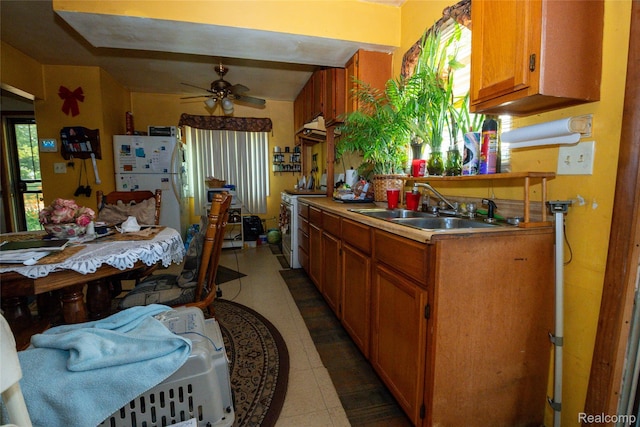 4315 Algonquin St, Detroit, MI 48215 - kitchen with white appliances, brown cabinetry, ceiling fan, and light countertops