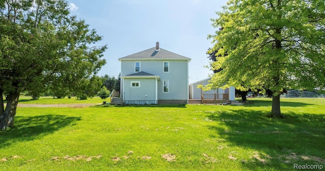 6550 Black River Rd, Croswell, MI 48422 - rear view of house with a lawn and a chimney