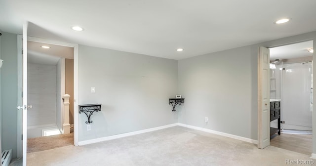 6550 Black River Rd, Croswell, MI 48422 - spare room with light carpet, recessed lighting, and a baseboard heating unit