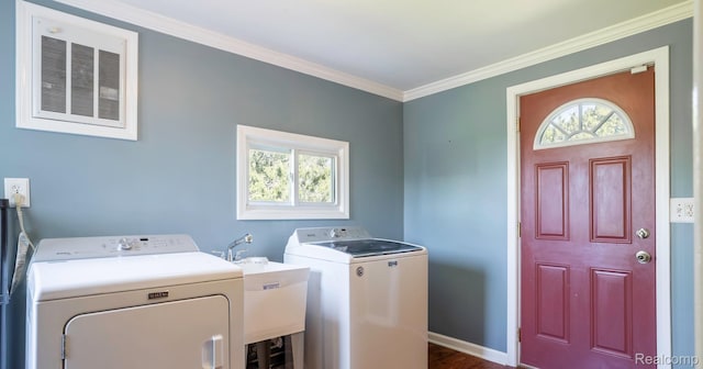 6550 Black River Rd, Croswell, MI 48422 - laundry room featuring washing machine and clothes dryer, ornamental molding, plenty of natural light, and dark wood-style flooring