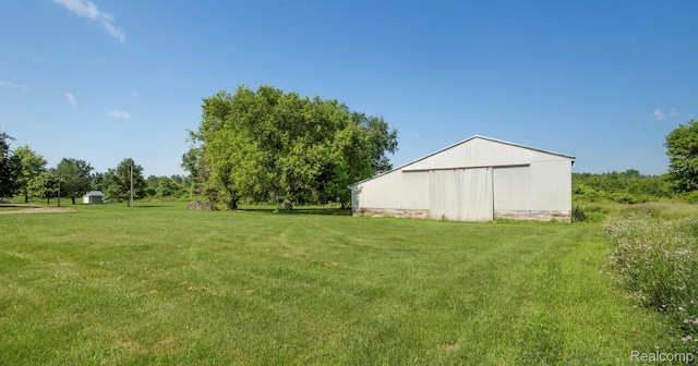 6550 Black River Rd, Croswell, MI 48422 - view of green lawn featuring an outbuilding and a pole building
