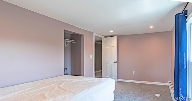 6550 Black River Rd, Croswell, MI 48422 - carpeted bedroom with recessed lighting, a closet, and a baseboard heating unit