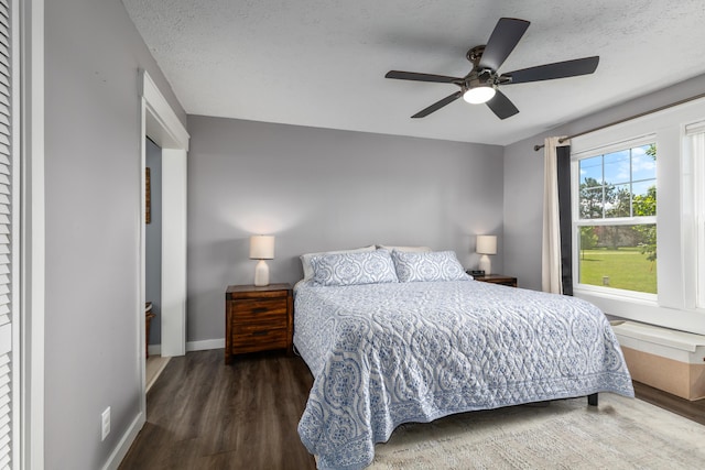 7241 Cherry Ave, Kewadin, MI 49648 - bedroom featuring wood finished floors, a ceiling fan, and a textured ceiling