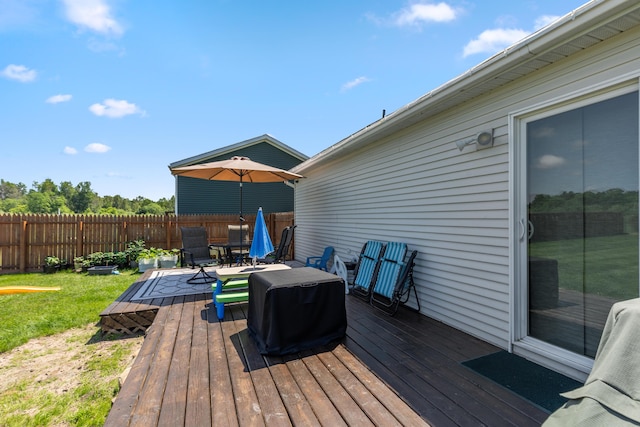 7241 Cherry Ave, Kewadin, MI 49648 - wooden deck featuring a grill