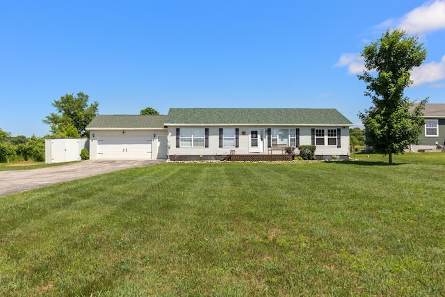 7241 Cherry Ave, Kewadin, MI 49648 - single story home featuring concrete driveway, a garage, and a front yard