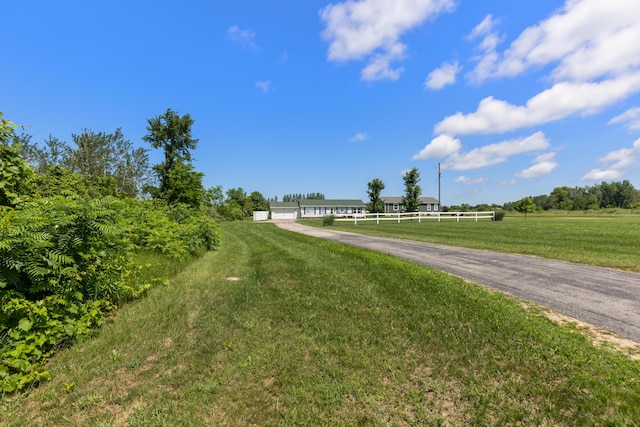 7241 Cherry Ave, Kewadin, MI 49648 - view of asphalt driveway with a view of countryside