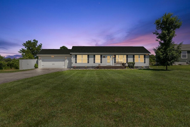 7241 Cherry Ave, Kewadin, MI 49648 - single story home featuring concrete driveway, covered porch, a yard, and a garage