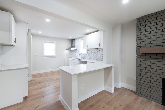 20157 Huntington Ave, Harper Woods, MI 48225 - kitchen with wall chimney exhaust hood, light wood-style flooring, backsplash, white cabinets, and recessed lighting