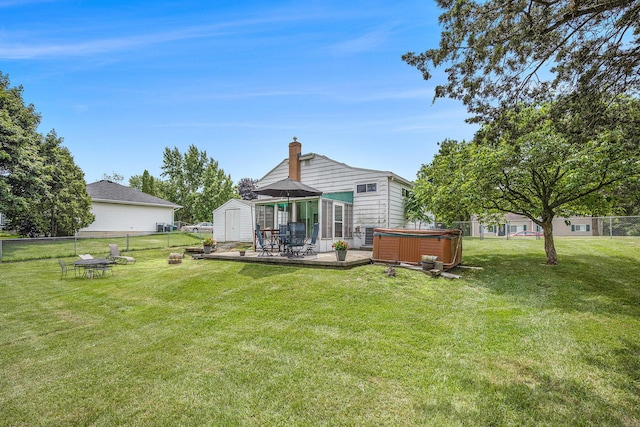 3477 Esson Dr, Grand Blanc, MI 48439 - back of house featuring a hot tub, a storage shed, a chimney, a fenced backyard, and a wooden deck