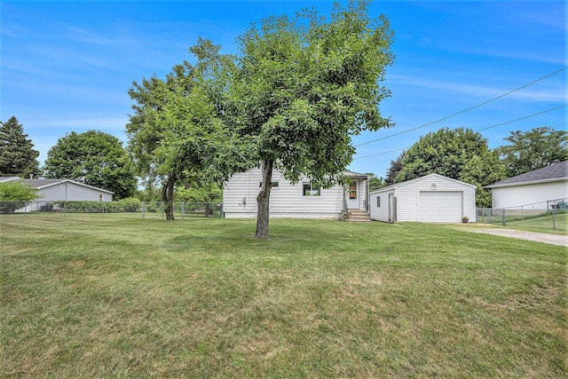 3477 Esson Dr, Grand Blanc, MI 48439 - view of yard featuring entry steps, driveway, a detached garage, and an outdoor structure