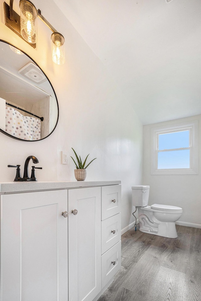 3477 Esson Dr, Grand Blanc, MI 48439 - bathroom featuring wood finished floors, vanity, and lofted ceiling