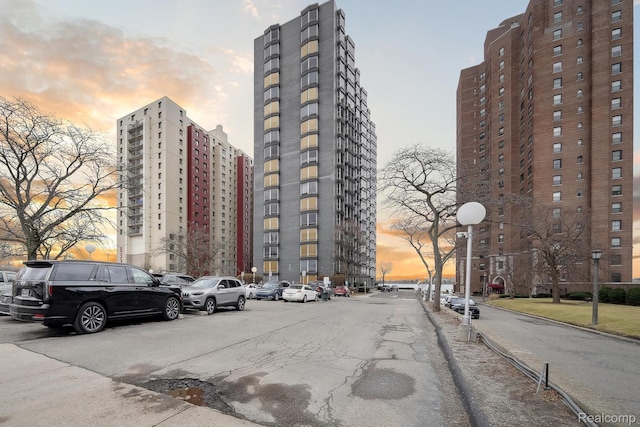 8200 E Jefferson # 1202, Detroit, MI 48214 - property at dusk featuring uncovered parking