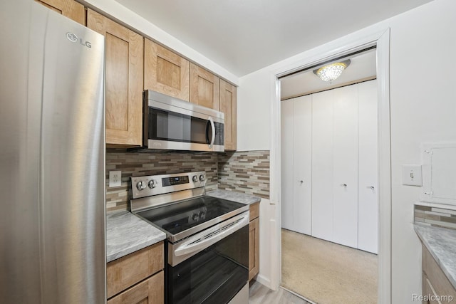 8200 E Jefferson # 1202, Detroit, MI 48214 - kitchen with stainless steel appliances, light countertops, tasteful backsplash, and light colored carpet