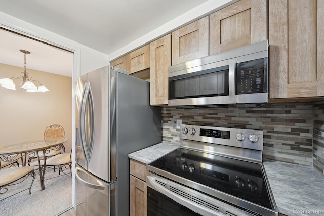 8200 E Jefferson # 1202, Detroit, MI 48214 - kitchen with appliances with stainless steel finishes, a chandelier, backsplash, and light brown cabinets