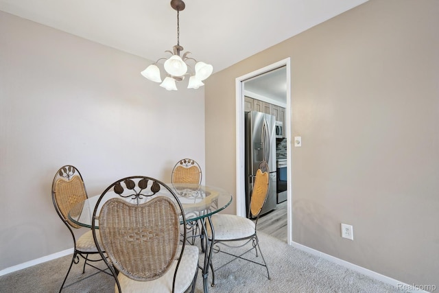 8200 E Jefferson # 1202, Detroit, MI 48214 - dining area with a chandelier and light carpet