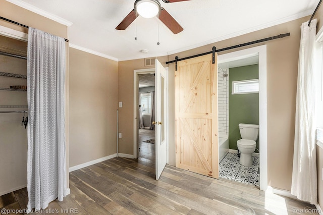 58 Yeamans St, Mount Clemens, MI 48043 - unfurnished bedroom with a barn door, wood finished floors, crown molding, ensuite bath, and ceiling fan