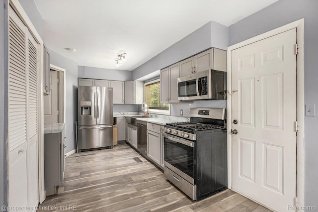 58 Yeamans St, Mount Clemens, MI 48043 - kitchen featuring appliances with stainless steel finishes, gray cabinetry, and light wood finished floors