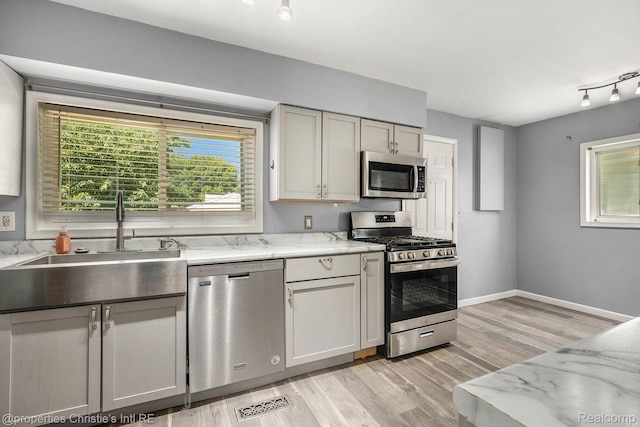 58 Yeamans St, Mount Clemens, MI 48043 - kitchen with appliances with stainless steel finishes, light wood-type flooring, and light stone countertops