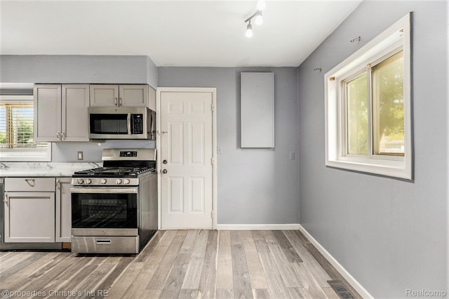 58 Yeamans St, Mount Clemens, MI 48043 - kitchen with stainless steel appliances, light wood finished floors, and gray cabinetry