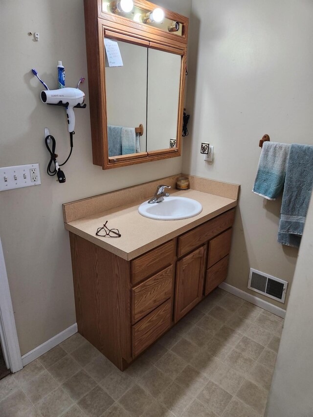 23967 Derek Dr, Sand Lake, MI 49343 - bathroom featuring vanity and baseboards