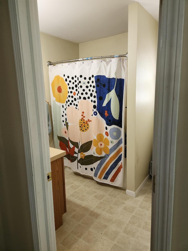 23967 Derek Dr, Sand Lake, MI 49343 - full bathroom with vanity, a shower with curtain, and tile patterned floors
