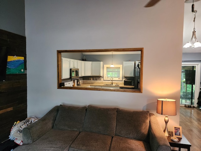 23967 Derek Dr, Sand Lake, MI 49343 - living room featuring wood finished floors, a towering ceiling, and ceiling fan