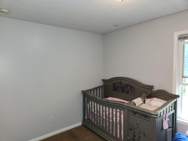 23967 Derek Dr, Sand Lake, MI 49343 - bedroom with dark colored carpet, multiple windows, and a nursery area