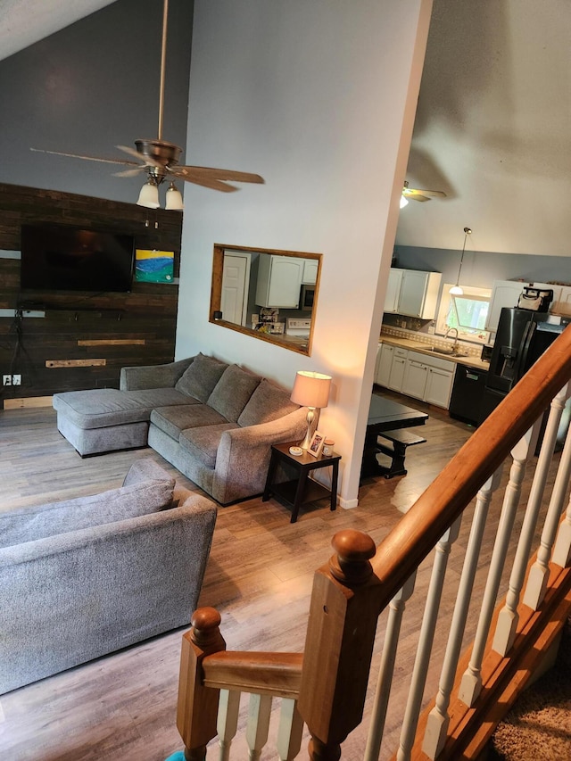 23967 Derek Dr, Sand Lake, MI 49343 - living room with ceiling fan, light wood finished floors, and a towering ceiling